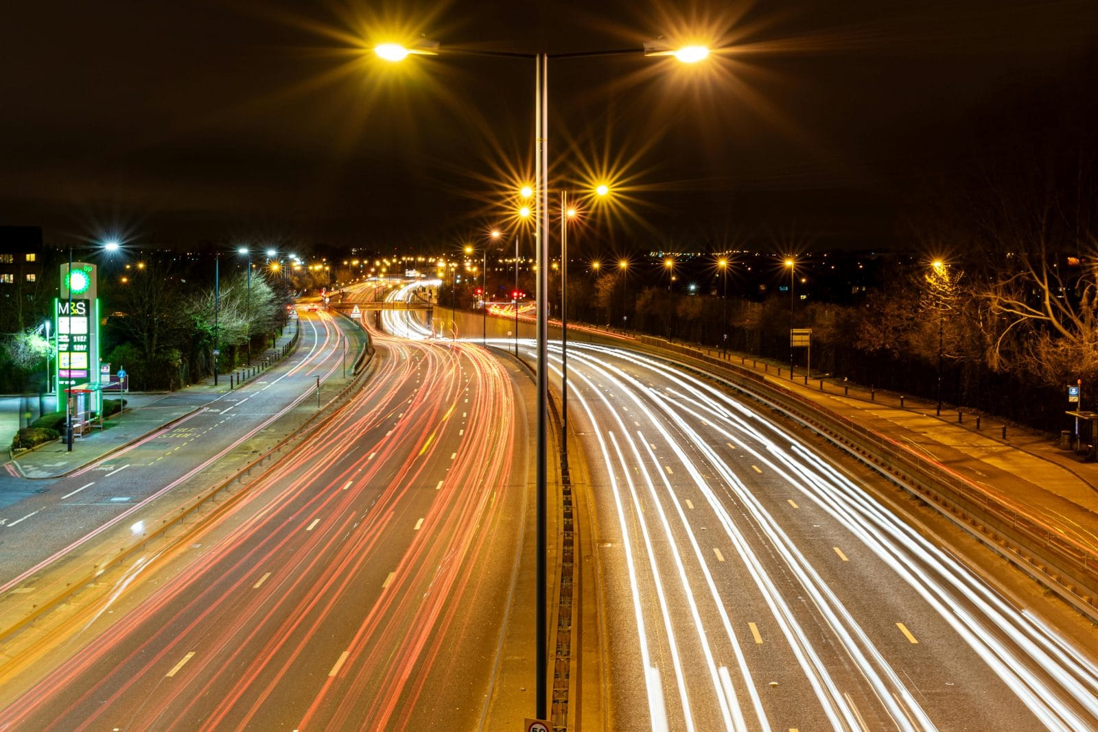 UK motorway with petrol and EV charging station to the side
