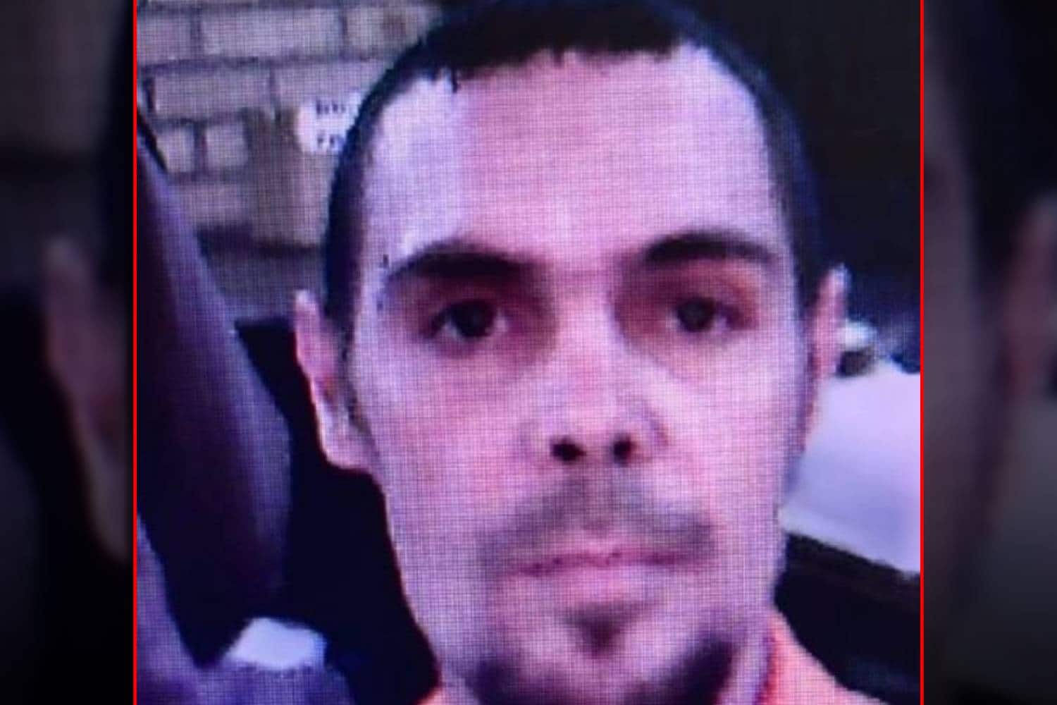 a man (Martin Jackson) with a serious face caught on CCTV, possibly a prisoner, possibly mixed race.