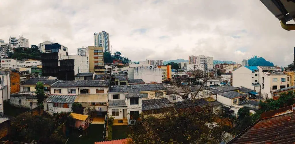 Many city buildings connected together, seen outside a window.