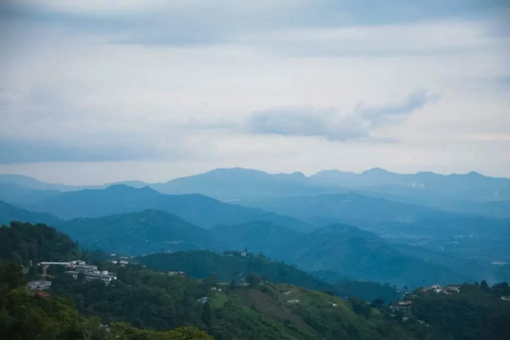 Layers of blue mountains seen from the edge of Manizales downtown.