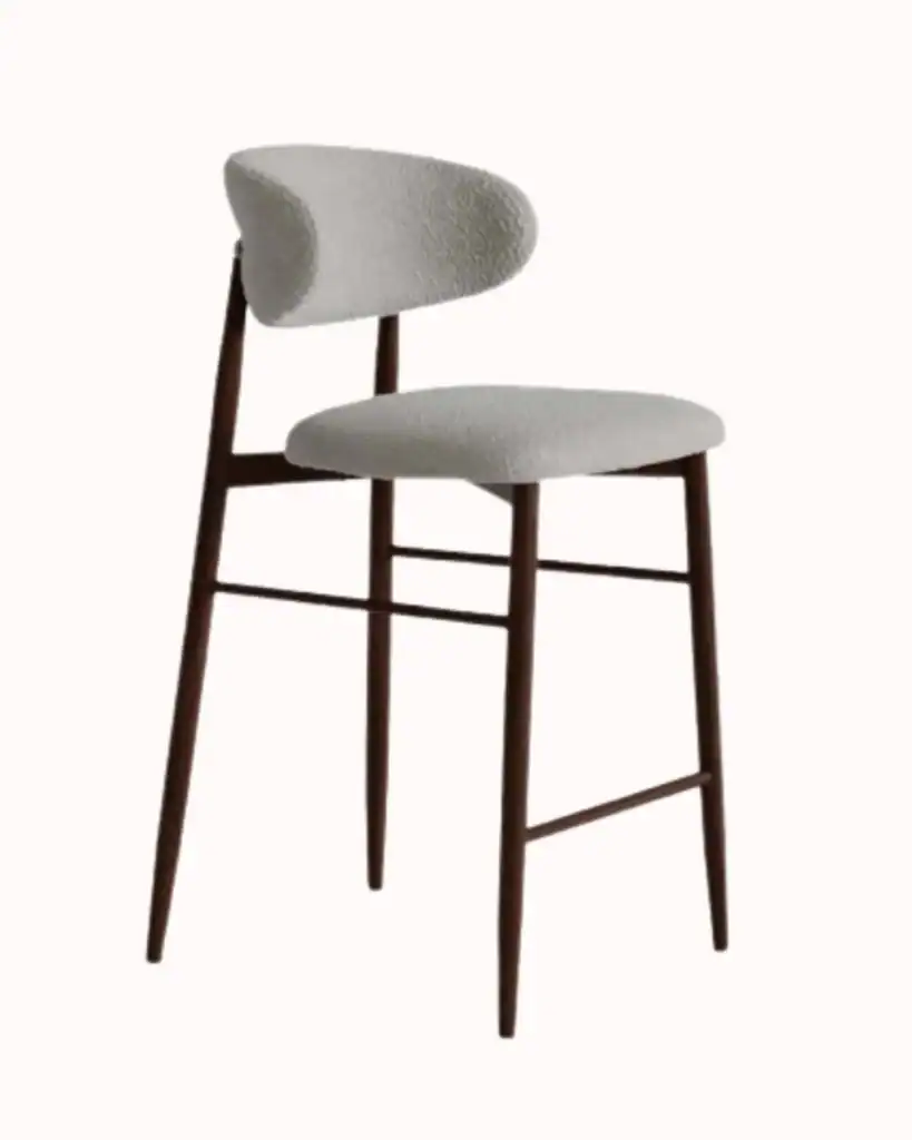 Light grey boucle bar stool on a plain pastel pink background.
