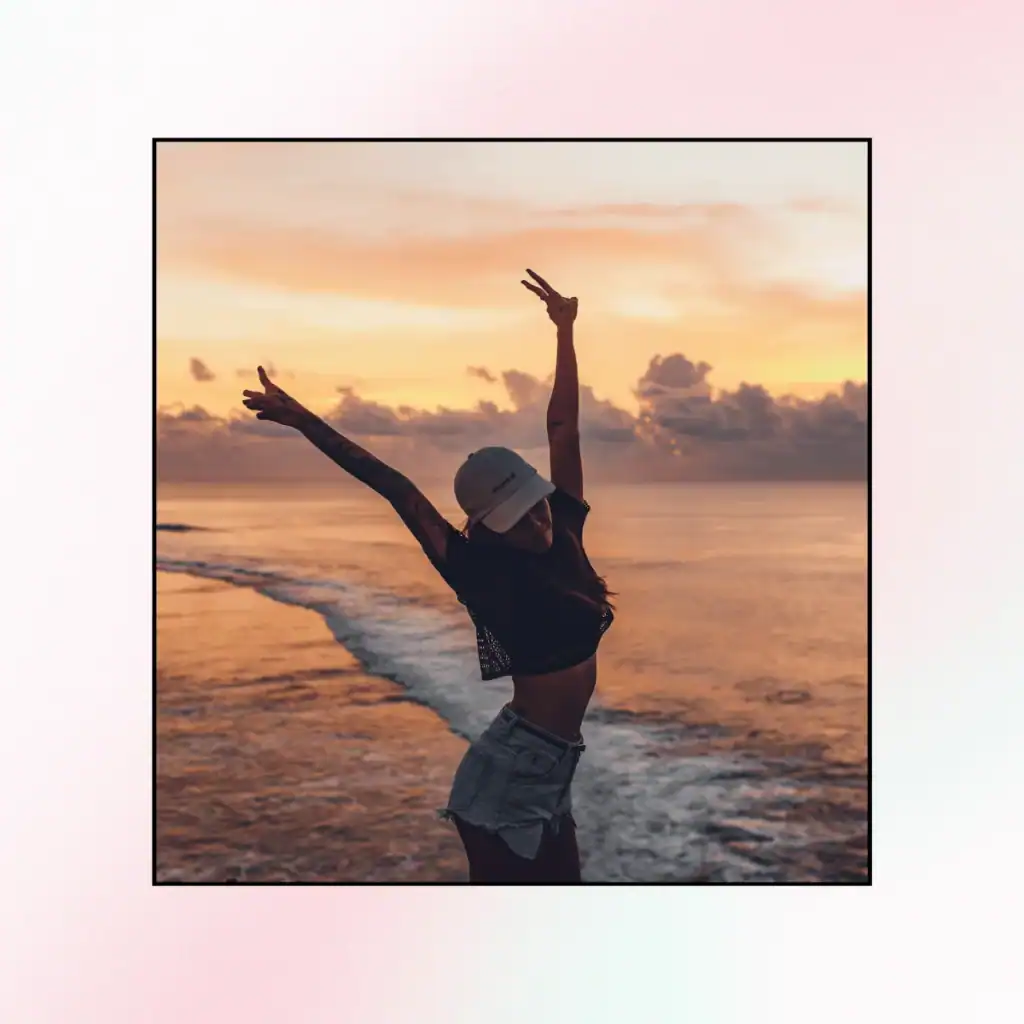 Happy woman with raised arms against seascape