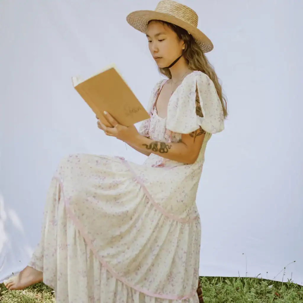 Self-Compassion-Journaling-Prompts.-Woman-in-a-summer-dress-reading