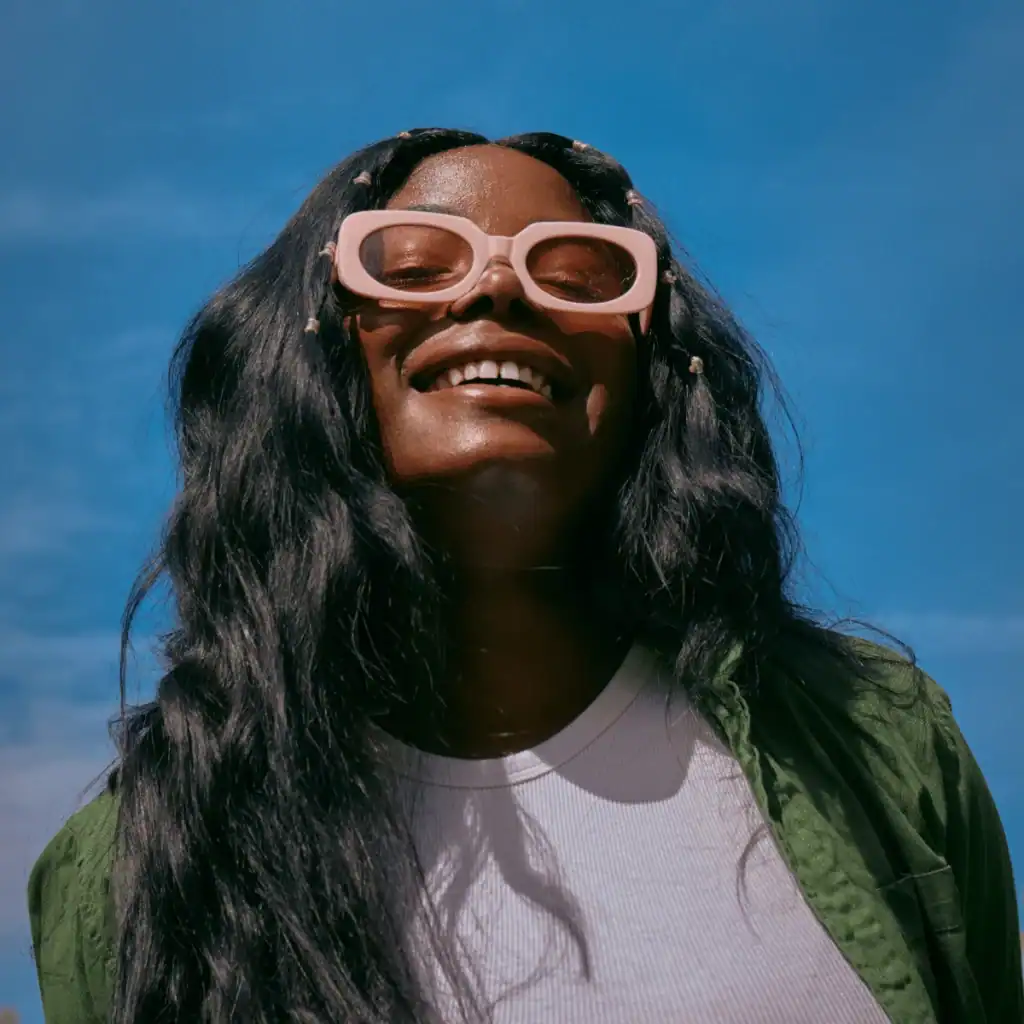 woman-smiling-with-pink-framed-glasses