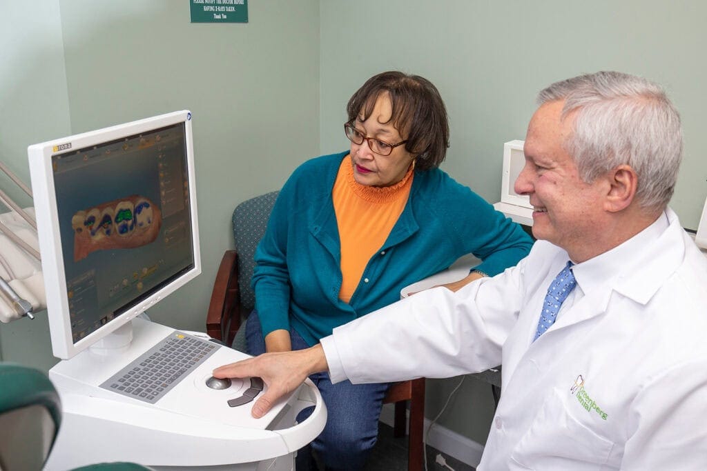 Dr. Randy Greenberg shows a patient scanned teeth on a CEREC scanner