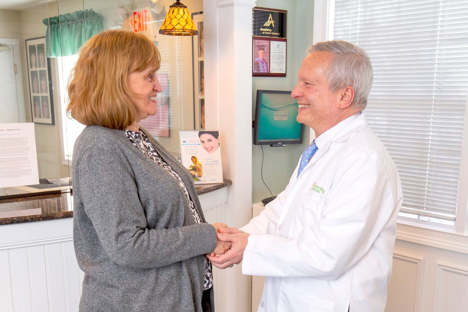 Dr. Randy Greenberg shaking hands with a patient