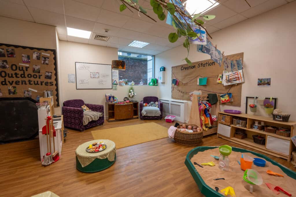Bright and welcoming indoor play area at Holyrood Nursery Princes Dock, featuring toys, cosy seating, and creative stations for young children’s development.