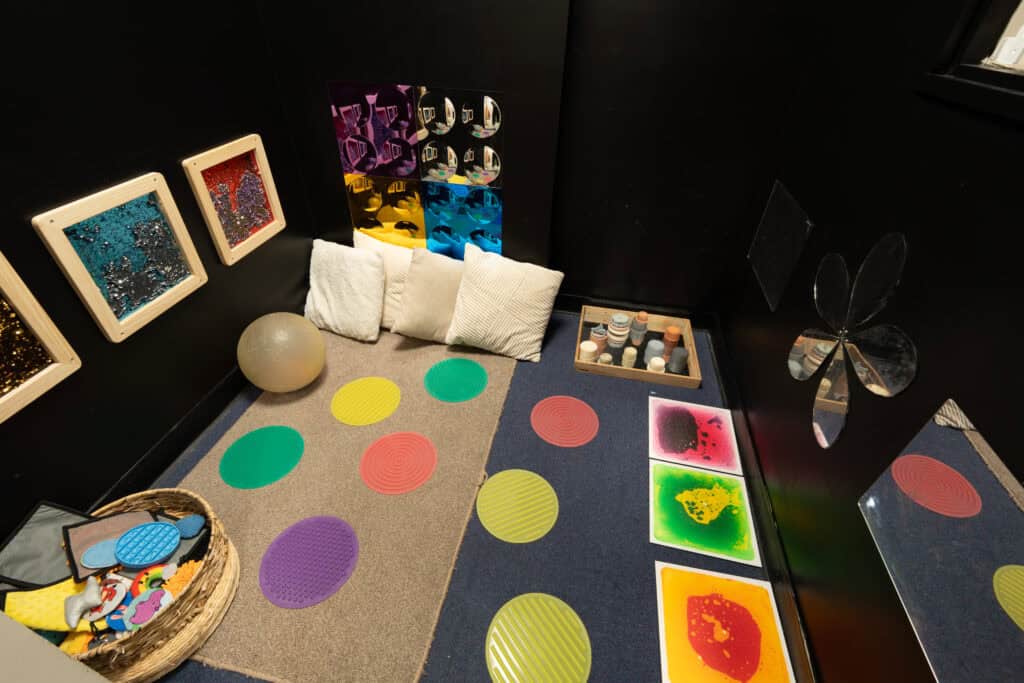 Playroom with colourful mats, cushions, and sensory toys for children at Holyrood Nursery Princes Dock.