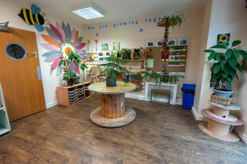 Bright, engaging interior with plants, artwork, and educational displays for young children.
