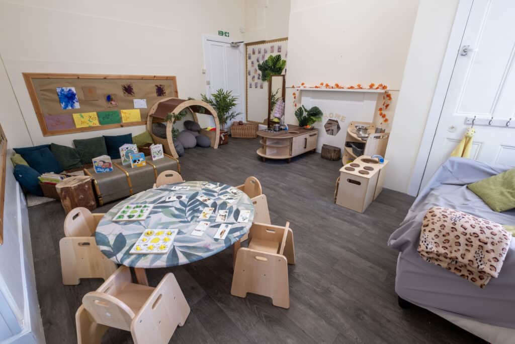 Bright and welcoming childcare room at Thrive Childcare featuring children’s play area, cosy reading nook, educational toys and activity stations, designed to foster learning, creativity, and fun for young children.