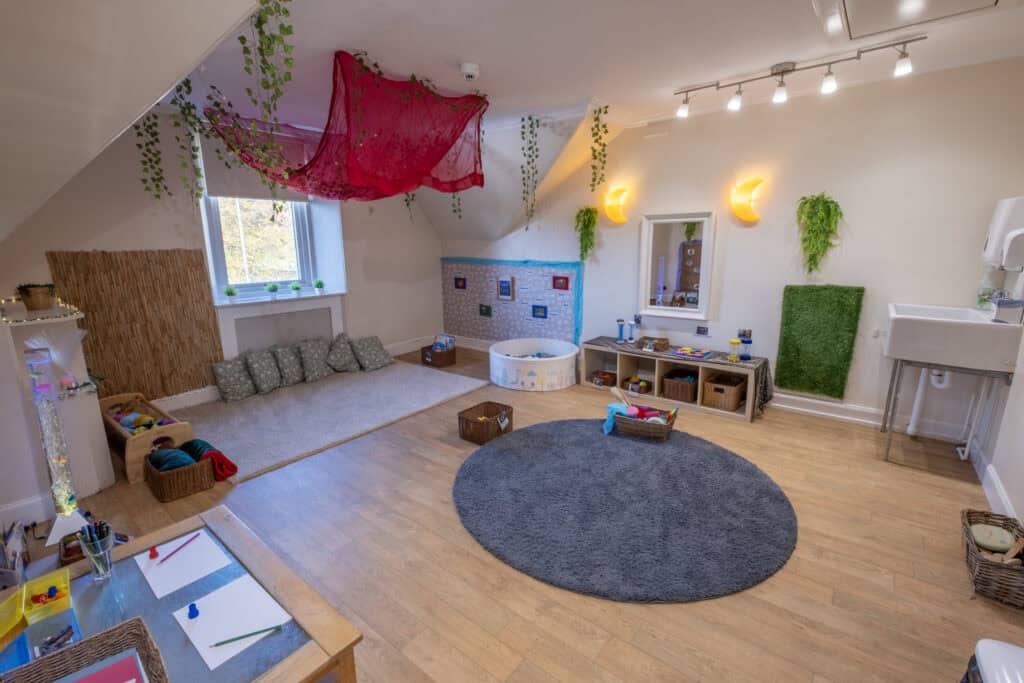 Bright and welcoming indoor playroom at Thrive Perth Meadows childcare centre, featuring a cozy corner, soft mats, and engaging toys for children’s development.