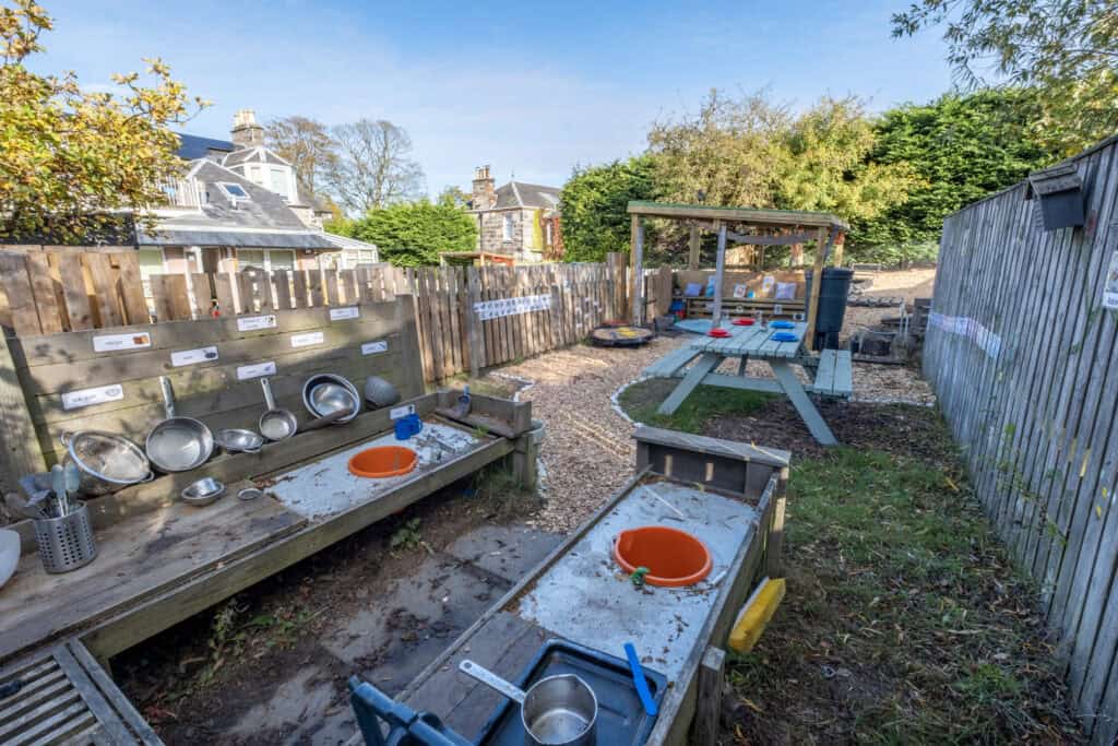 Bright outdoor play and learning area at Thrive Childcare, featuring sensory and water play stations, perfect for early childhood development and educational activities.
