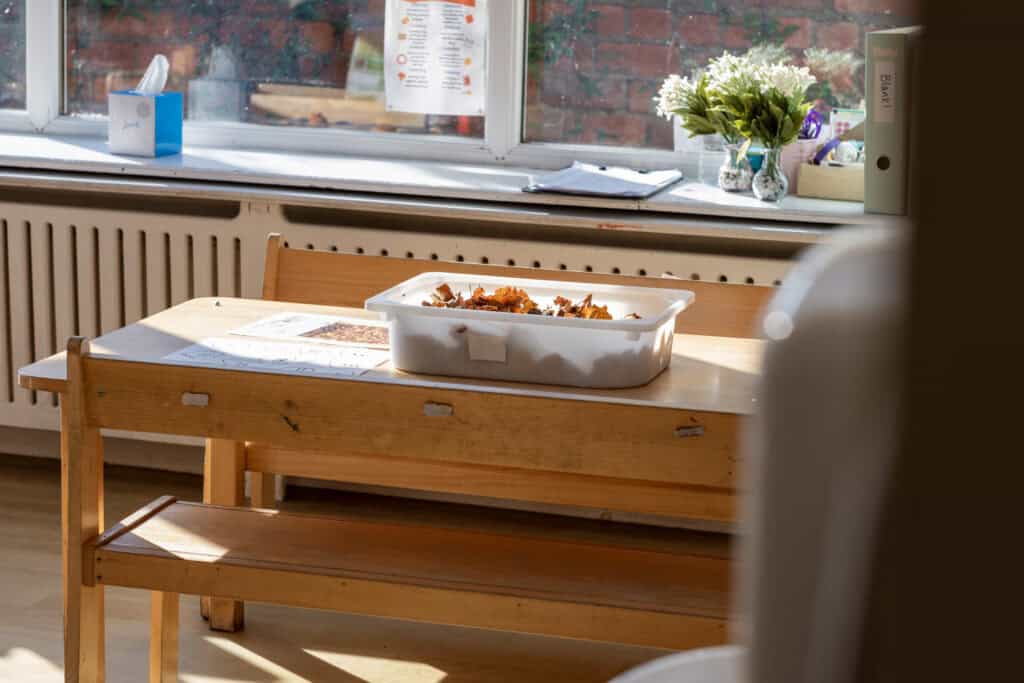 A tray of children's food placed on a wooden table inside a nursery classroom at Thrive Childcare.