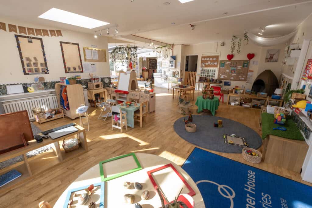 Bright, welcoming nursery classroom at Thrive Childcare with engaging play areas, educational toys, craft stations, and cosy corners designed to support early childhood development and learning.