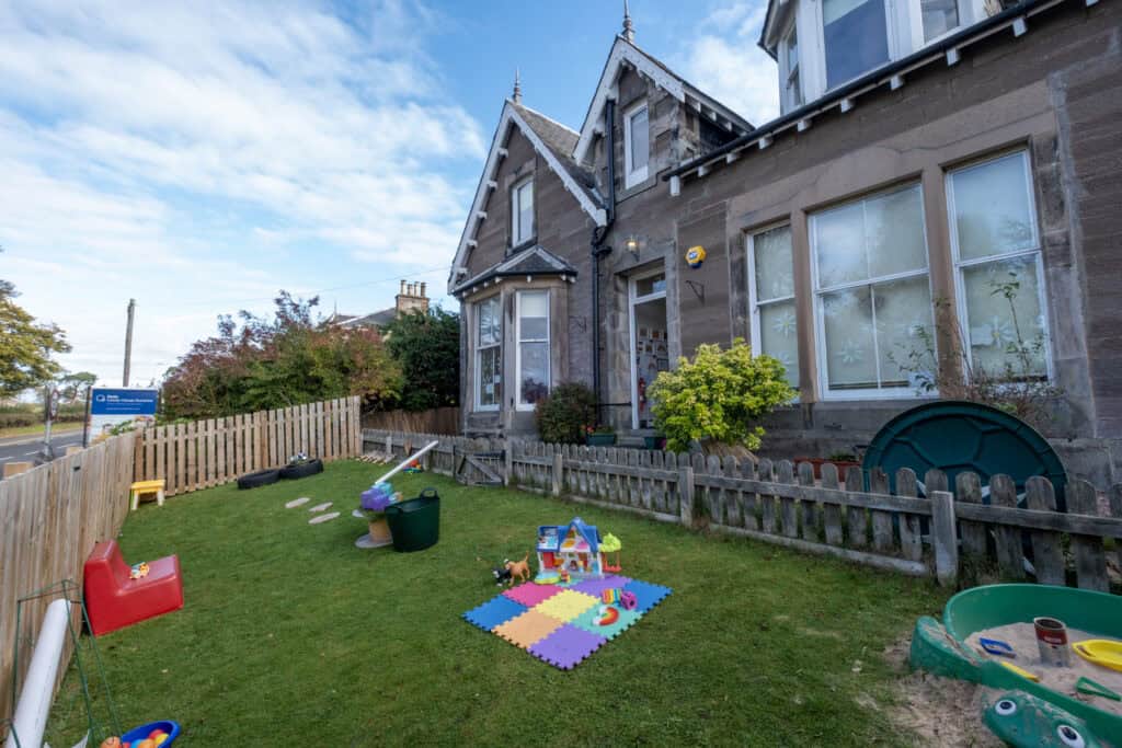 Bright childcare centre building with a garden play area, colourful toys and outdoor activities, ideal for early childhood development, trusted by local families in a safe, welcoming environment.