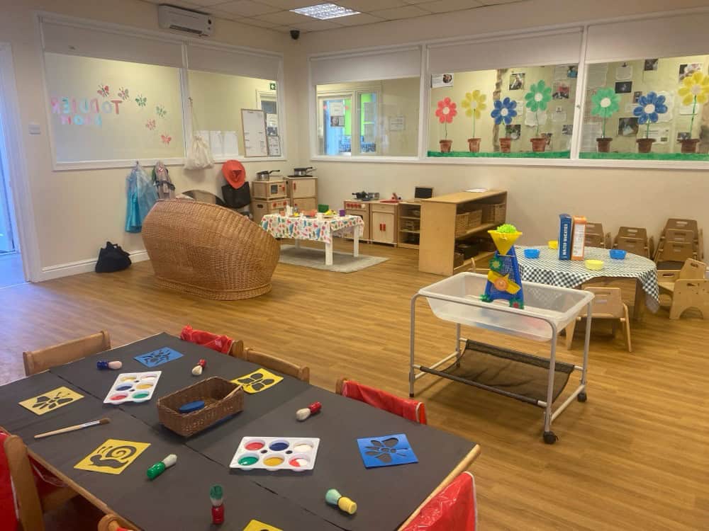 Bright and welcoming nursery room at Holyrood Nursery Swinton, featuring colourful decorations, educational toys, and comfortable furniture designed for early childhood development.