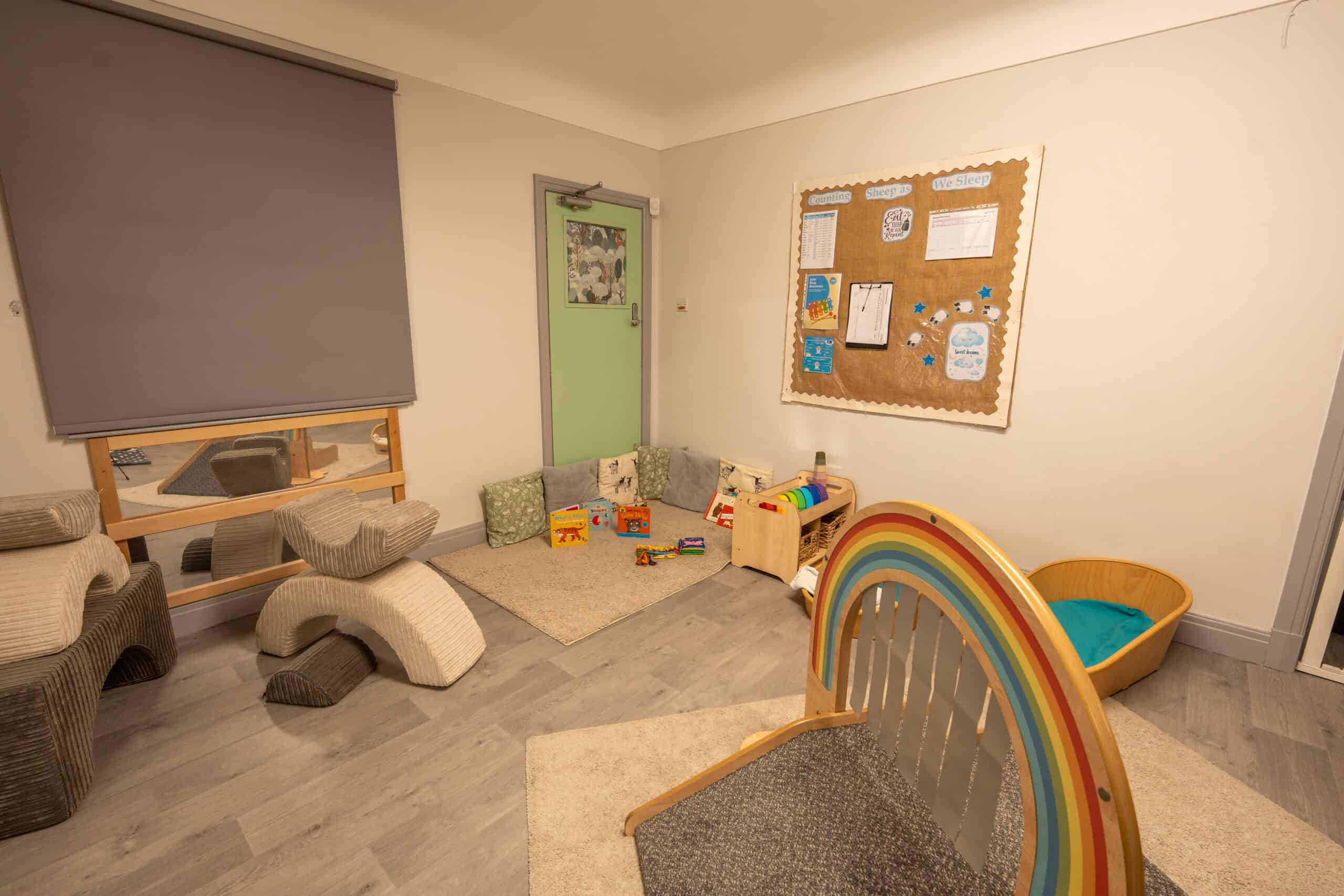 Playroom at Thrive Grosvenor House childcare centre with colourful toys, soft seating, and engaging learning areas for children.