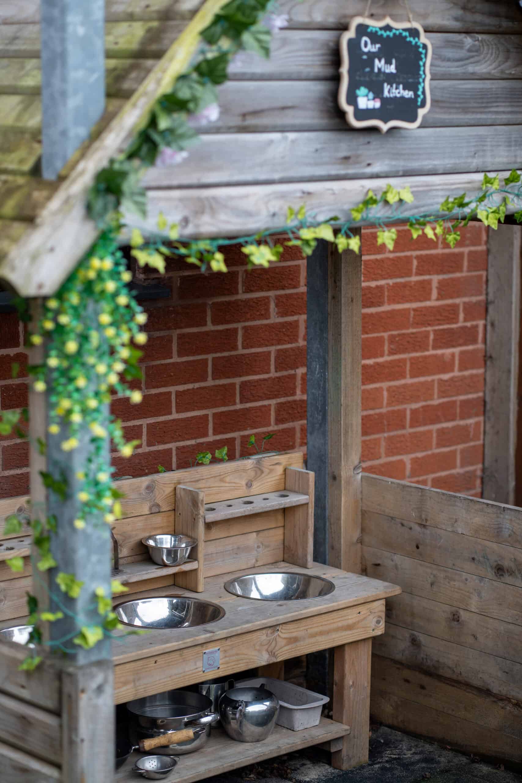 Outdoor children's play kitchen at Thrive Grosvenor House childcare centre.