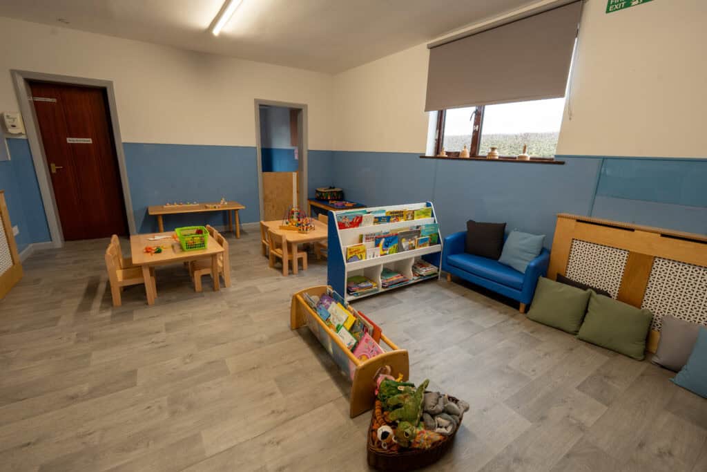 Bright and welcoming childcare room with toys, books, and comfortable seating, designed to create a nurturing environment for children at Thrive Childcare.
