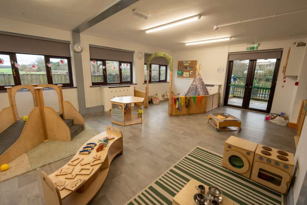 An inviting indoor playroom at Thrive Grosvenor House, designed for young children with engaging toys, soft play zones, and comfortable seating to support early development and fun.