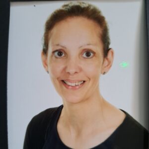 Supportive childcare professional with a warm smile at Thrive Childcare, dedicated to nurturing young children in a safe and engaging environment, promoting learning and development.