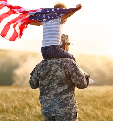 veterans survivor benifits, image of old veteran with grandson on his shoulders.