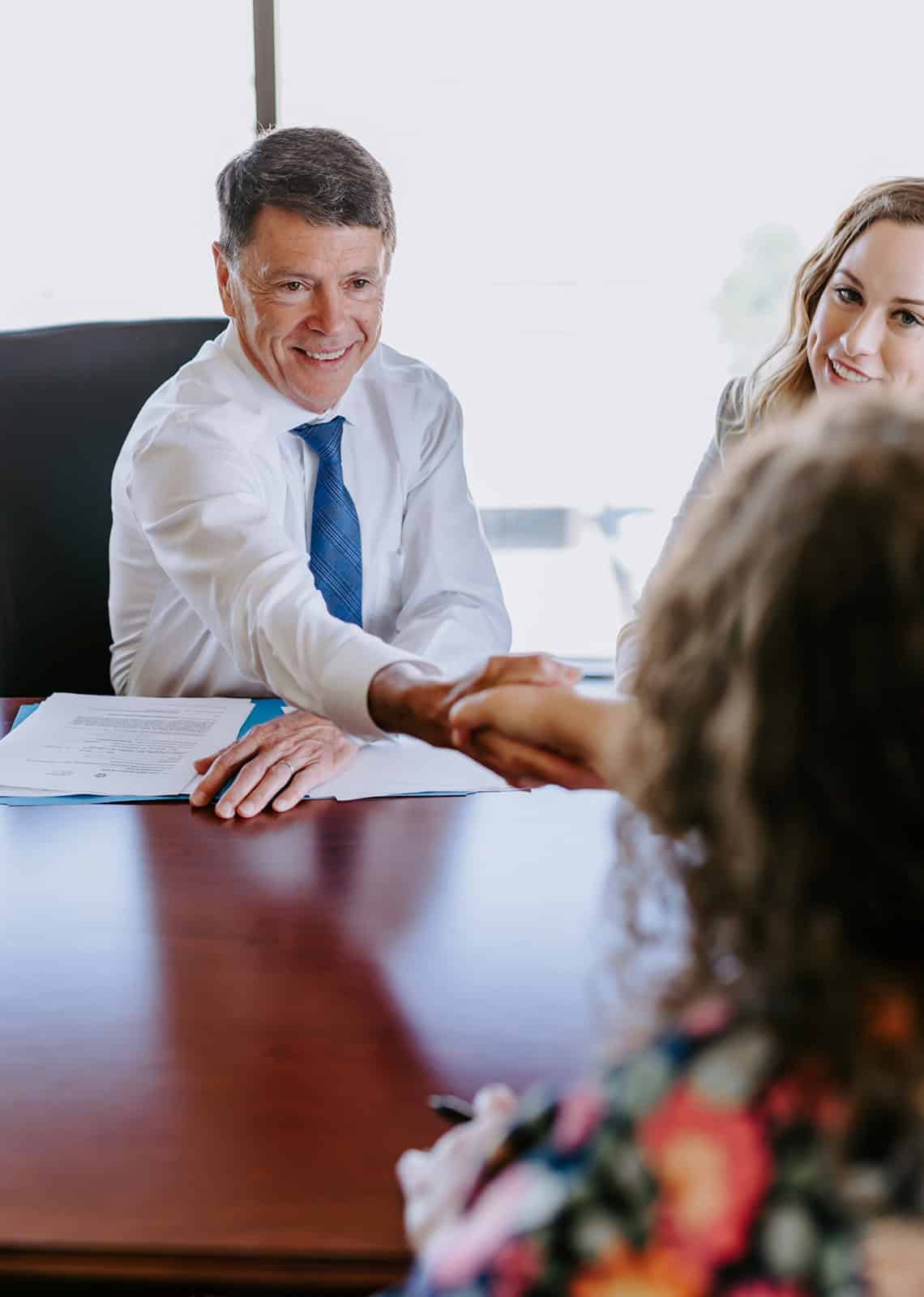 Experienced attorney from Tuley Law Office shaking hands with a client during a consultation about personal injury or legal representation.