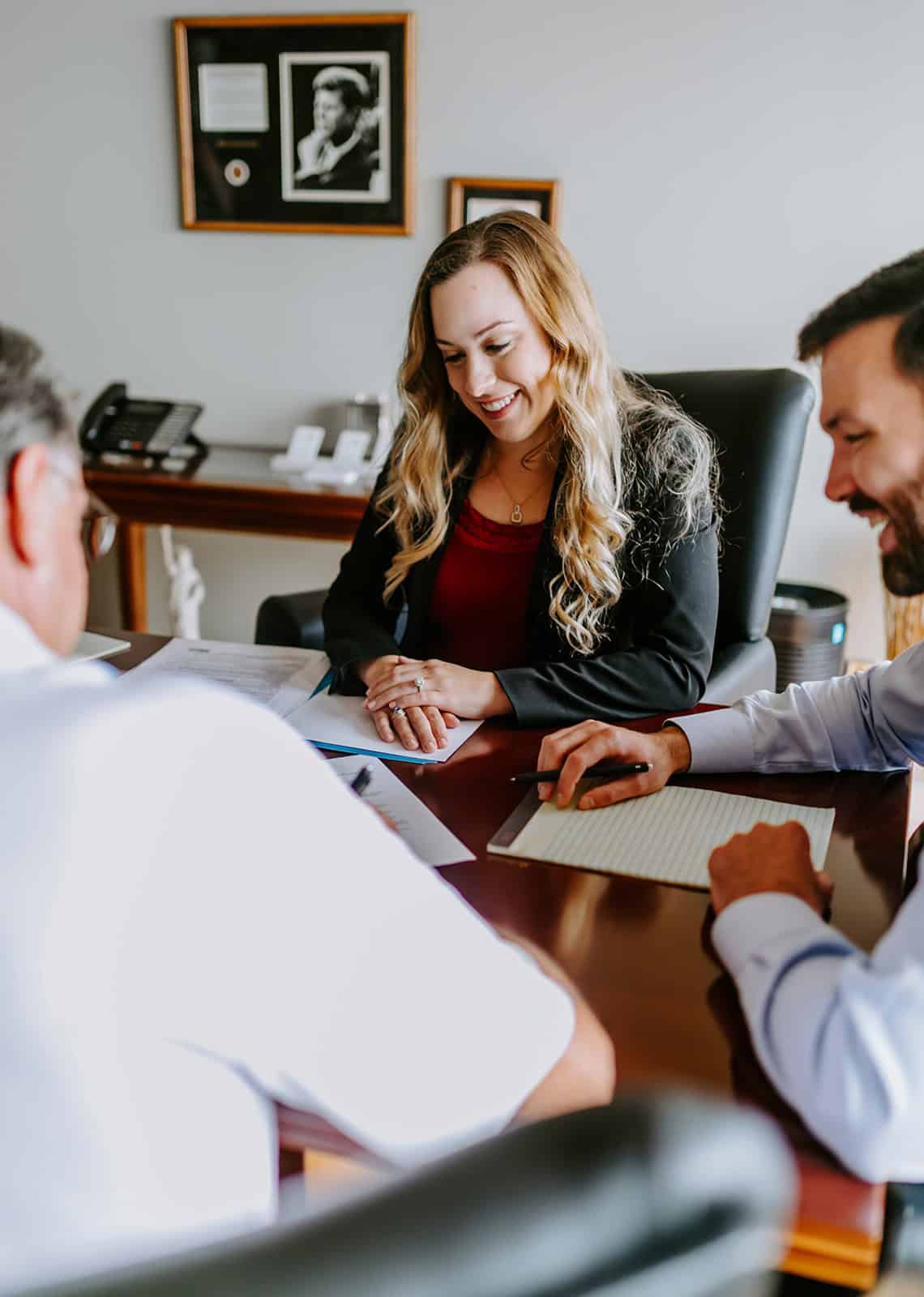 Experienced lawyer consulting with clients in an office to provide legal advice and support for personal injury or family law cases. Friendly professional interaction for effective legal representation.