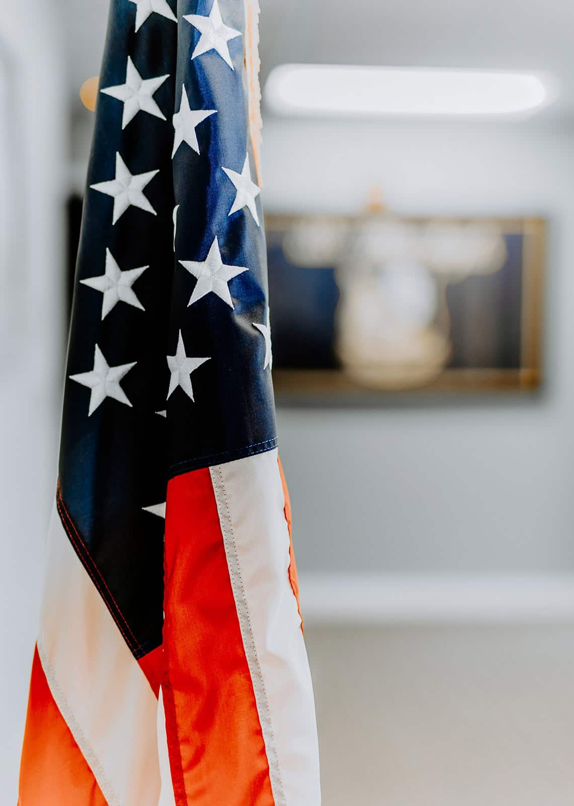 U.S. flag hanging indoors, symbolizing patriotism, law, and justice, representative of Tuley Law Office's commitment to legal service excellence and American values.