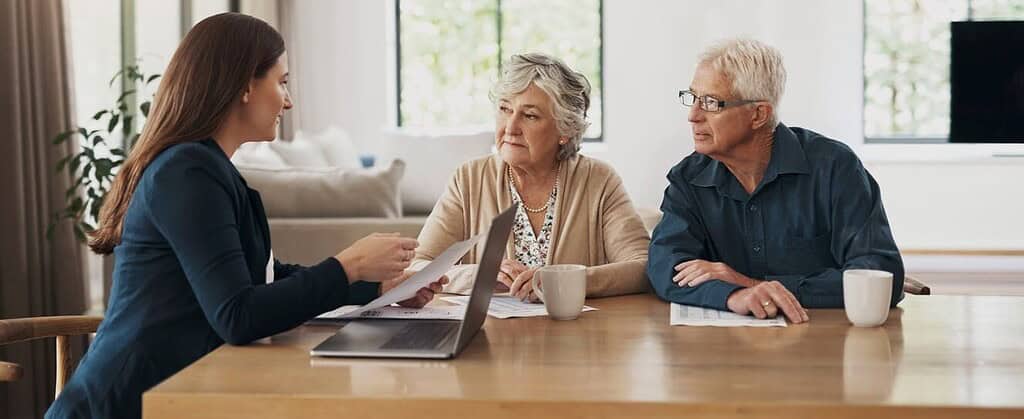 Professional lawyer consulting with elderly clients in a legal advice session, focusing on estate planning and elder law services at Tuley Law Office.