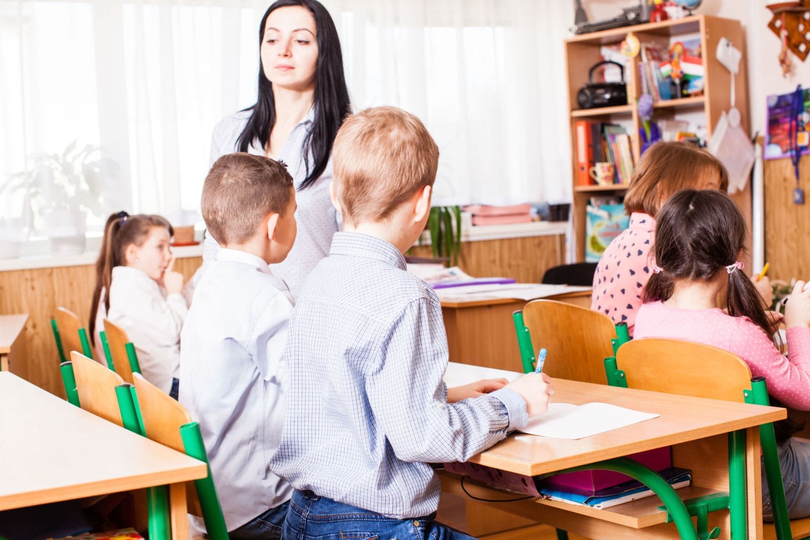 side view girl sitting table