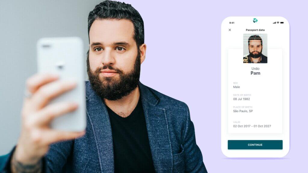 A man with dark hair and a beard verifying his identify with Face Match