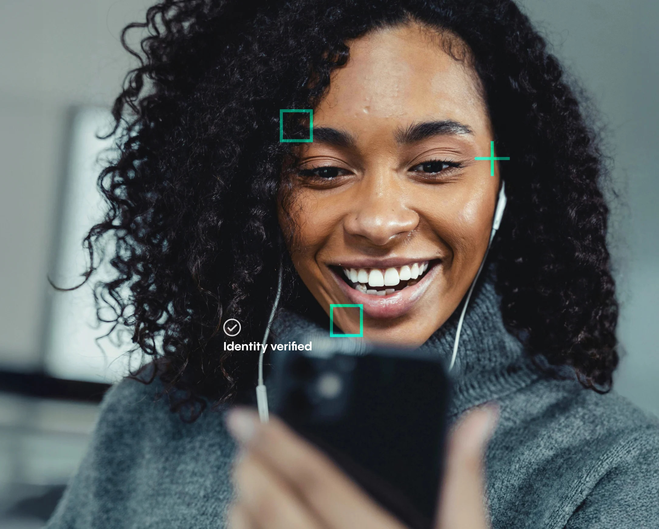 a woman smiling with earphones and a phone