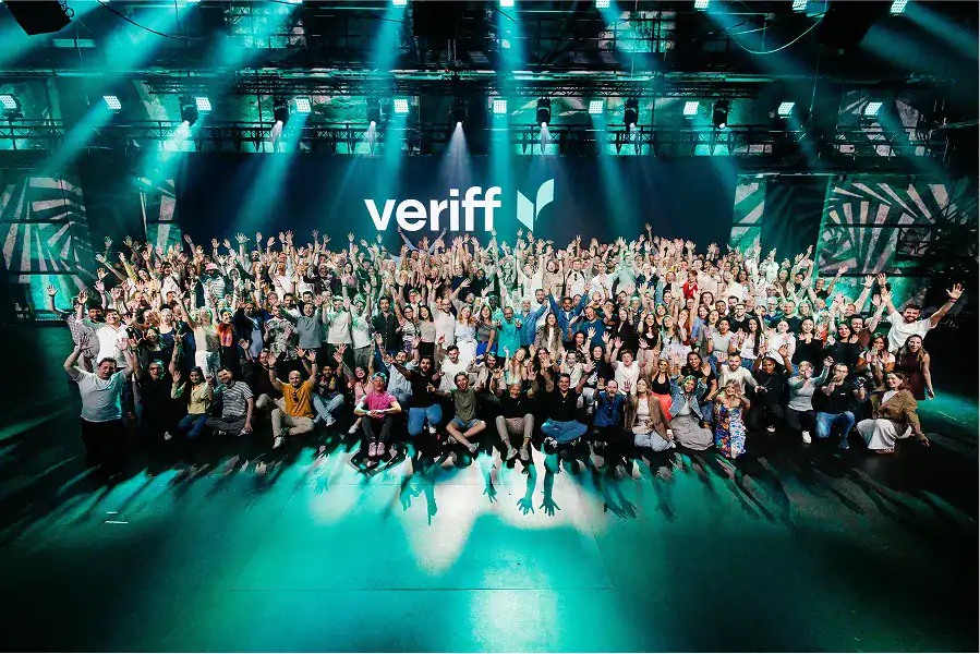 group of people on a stage bellow a veriff logo