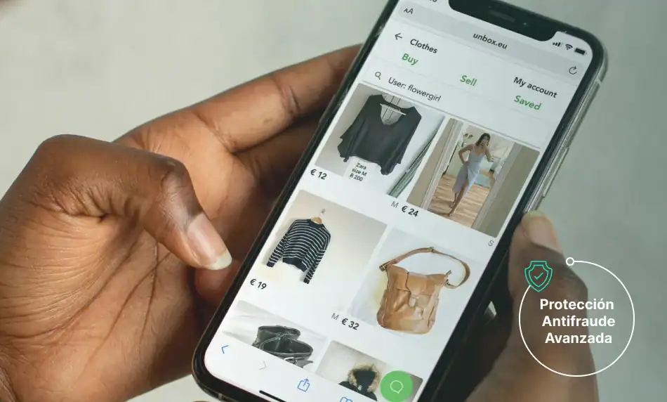 a hand holding a phone with a screen showing a picture of clothes