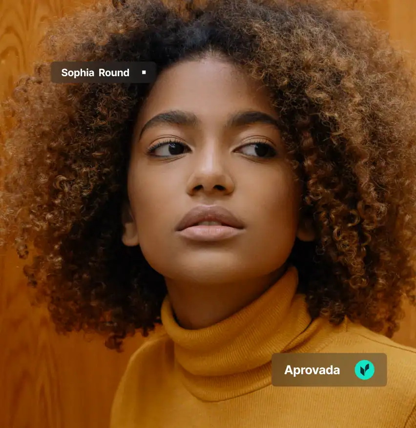 Person with curly hair, wearing turtleneck.