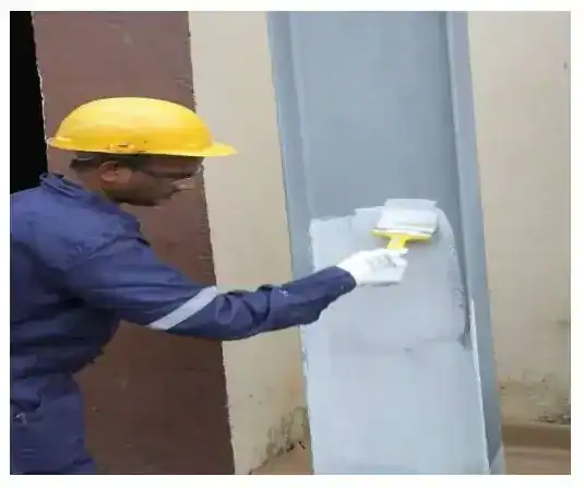 Worker applies passive fire protection coating