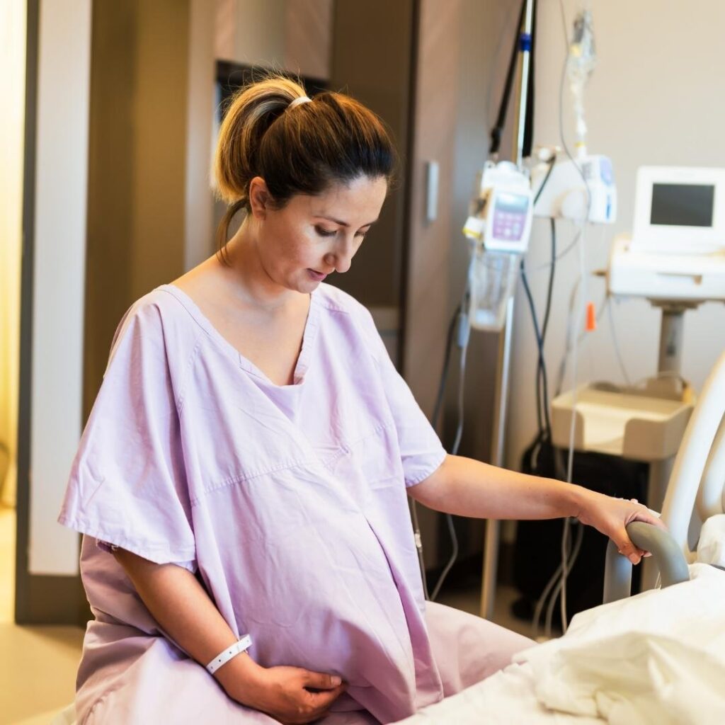 laboring mother in the hospital in a pink johnny