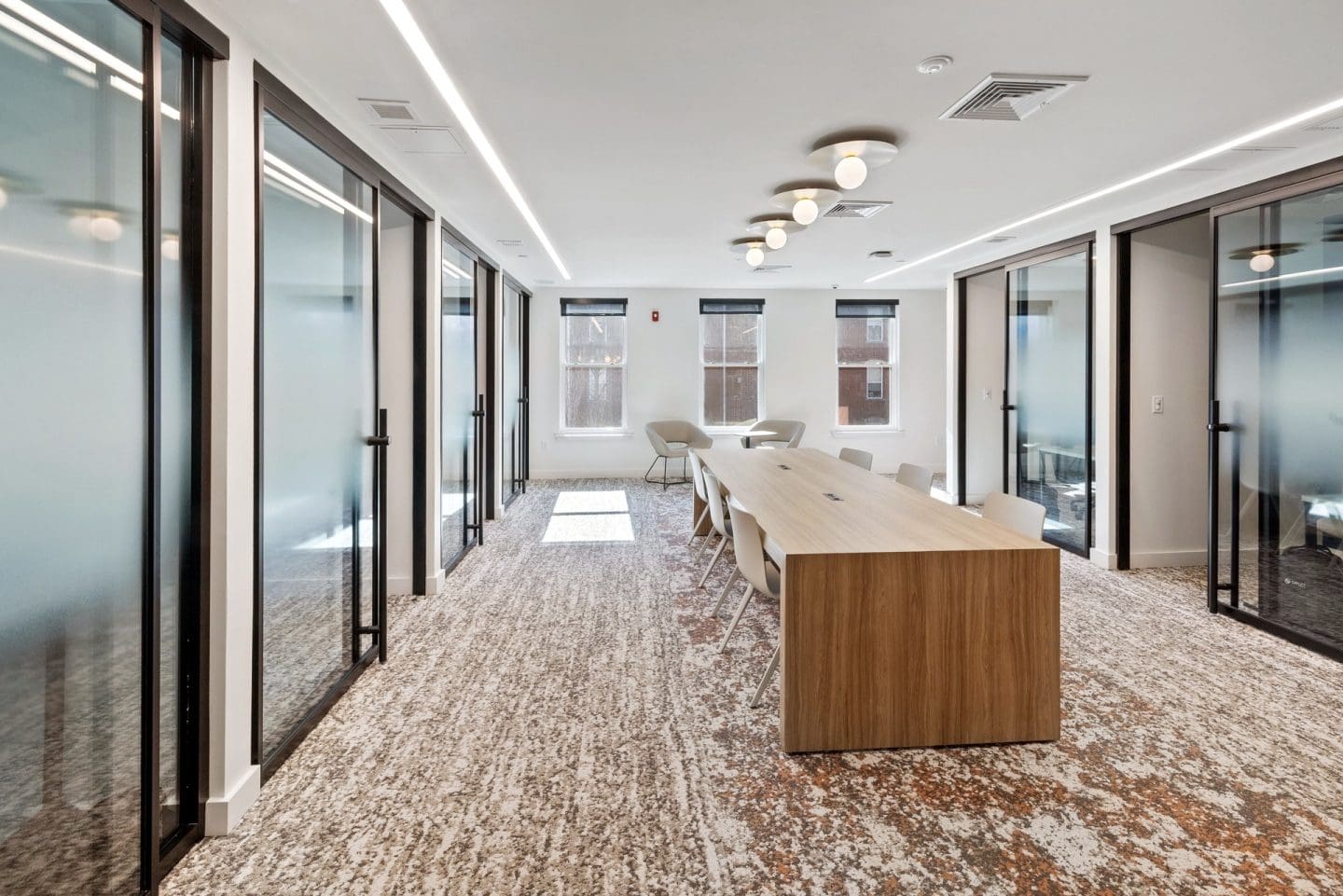 A conference room with a long table and chairs.