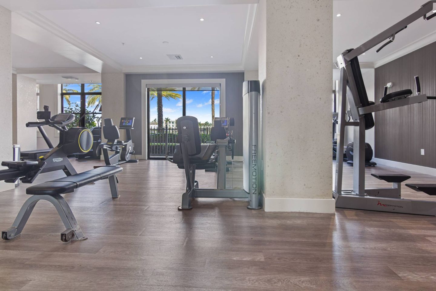 A gym with treadmills, elliptical machines, and other exercise equipment.