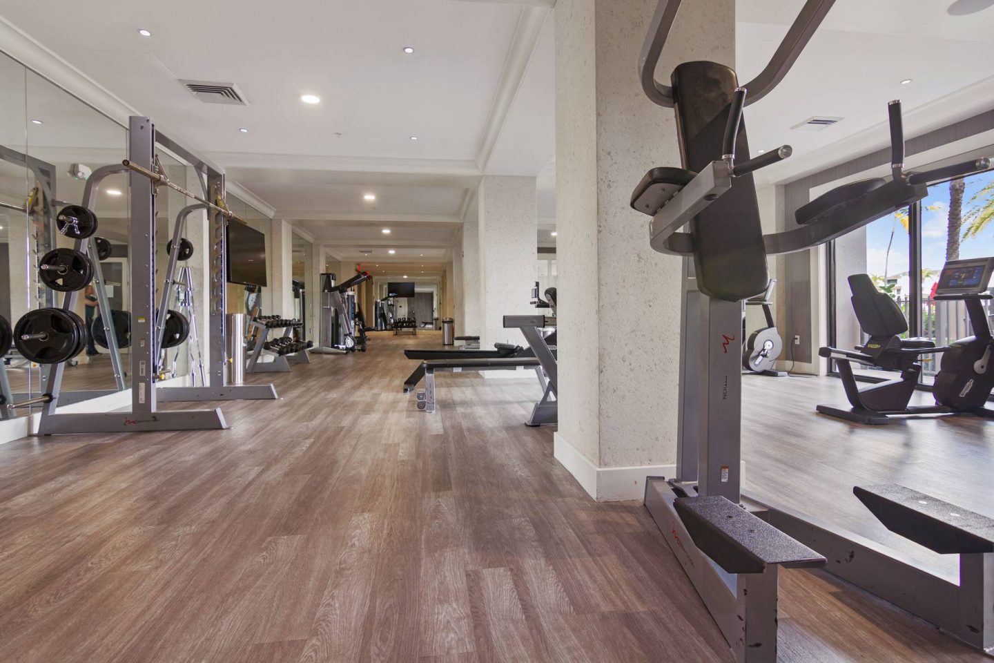 A gym with a variety of equipment including a leg press machine.