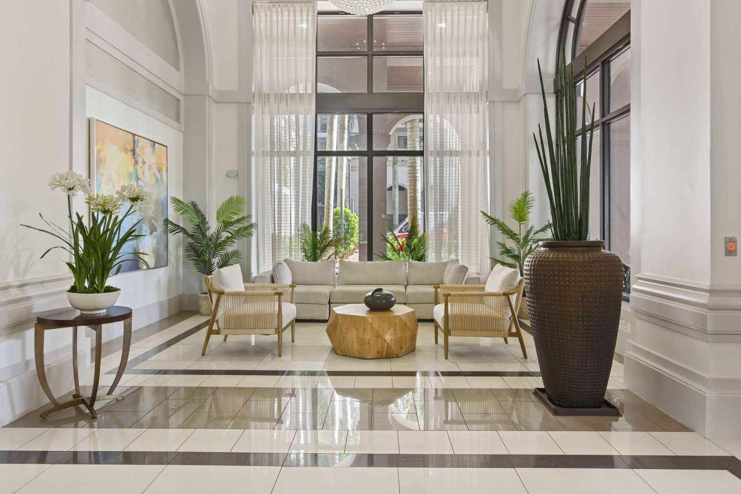 A living room with a white sofa and a brown coffee table.
