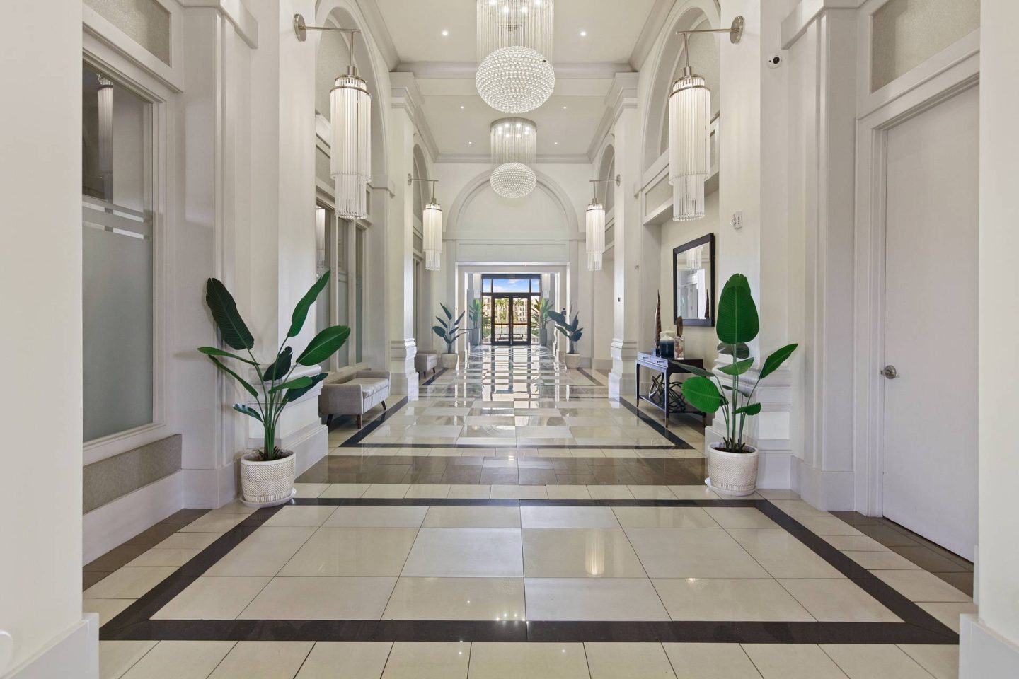 A long hallway with a tiled floor and white walls.