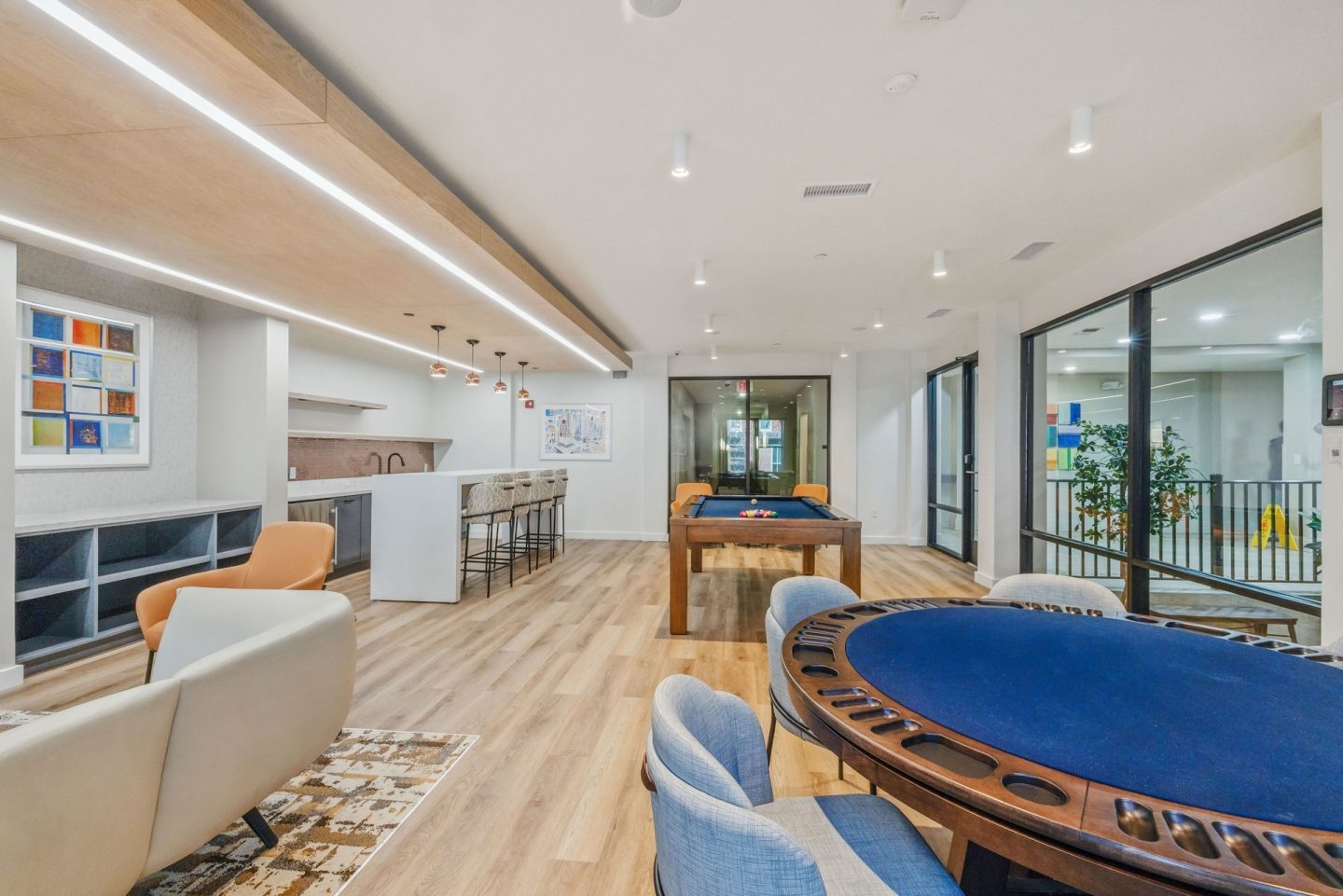 A room with a pool table and a bar.