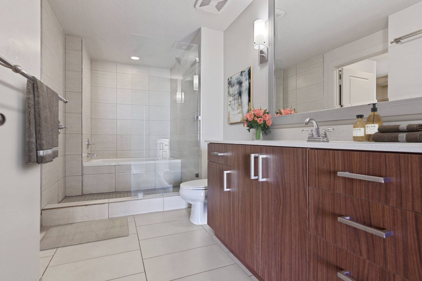 A modern bathroom with a walk-in shower and a toilet.