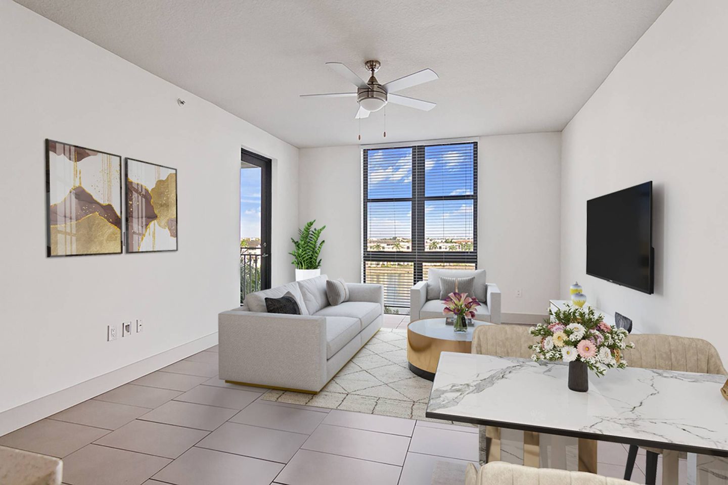 A living room with a couch, a chair, a table, and a television.