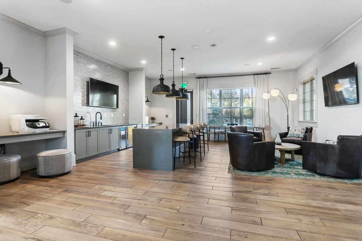 Clubhouse lounge and kitchenette at Windsor Sugarloaf 1455 Satellite Blvd Suwanee GA 30024 featuring lounge seating bar seating beverage area and natural light intentionally captured without computers per onsite updates