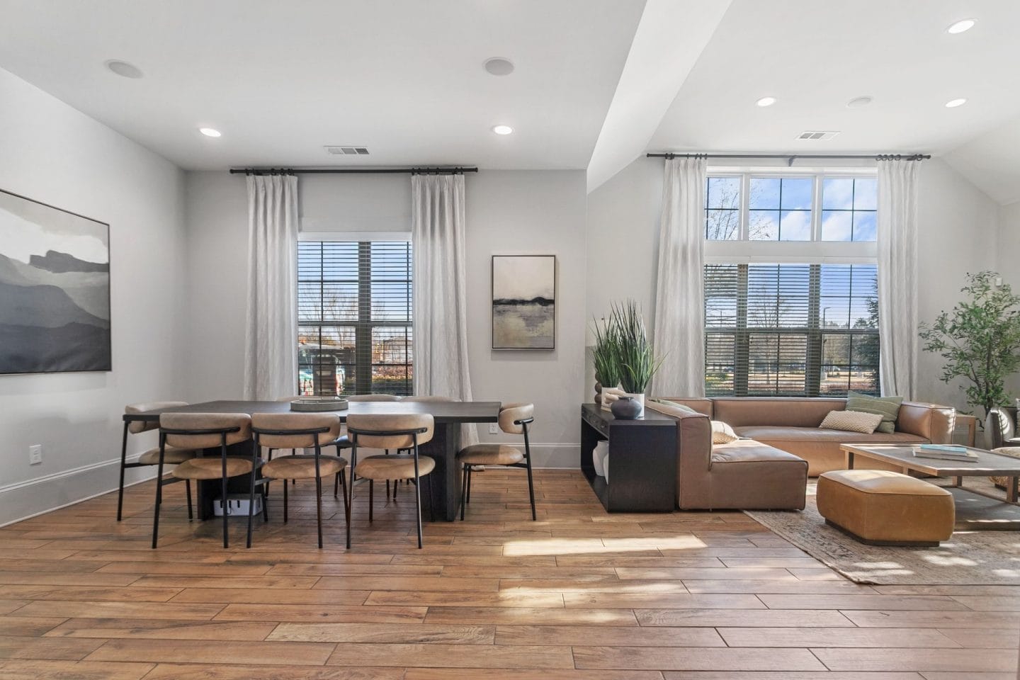 A modern living room with a dining table and chairs.