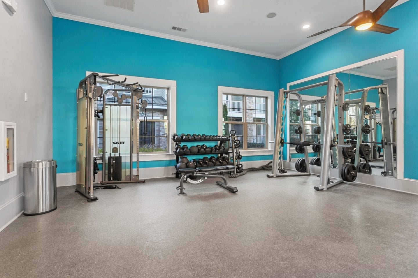 Fitness center at Windsor Sugarloaf 1455 Satellite Blvd Suwanee GA 30024 featuring smith machine cable stations free weights and bright natural light