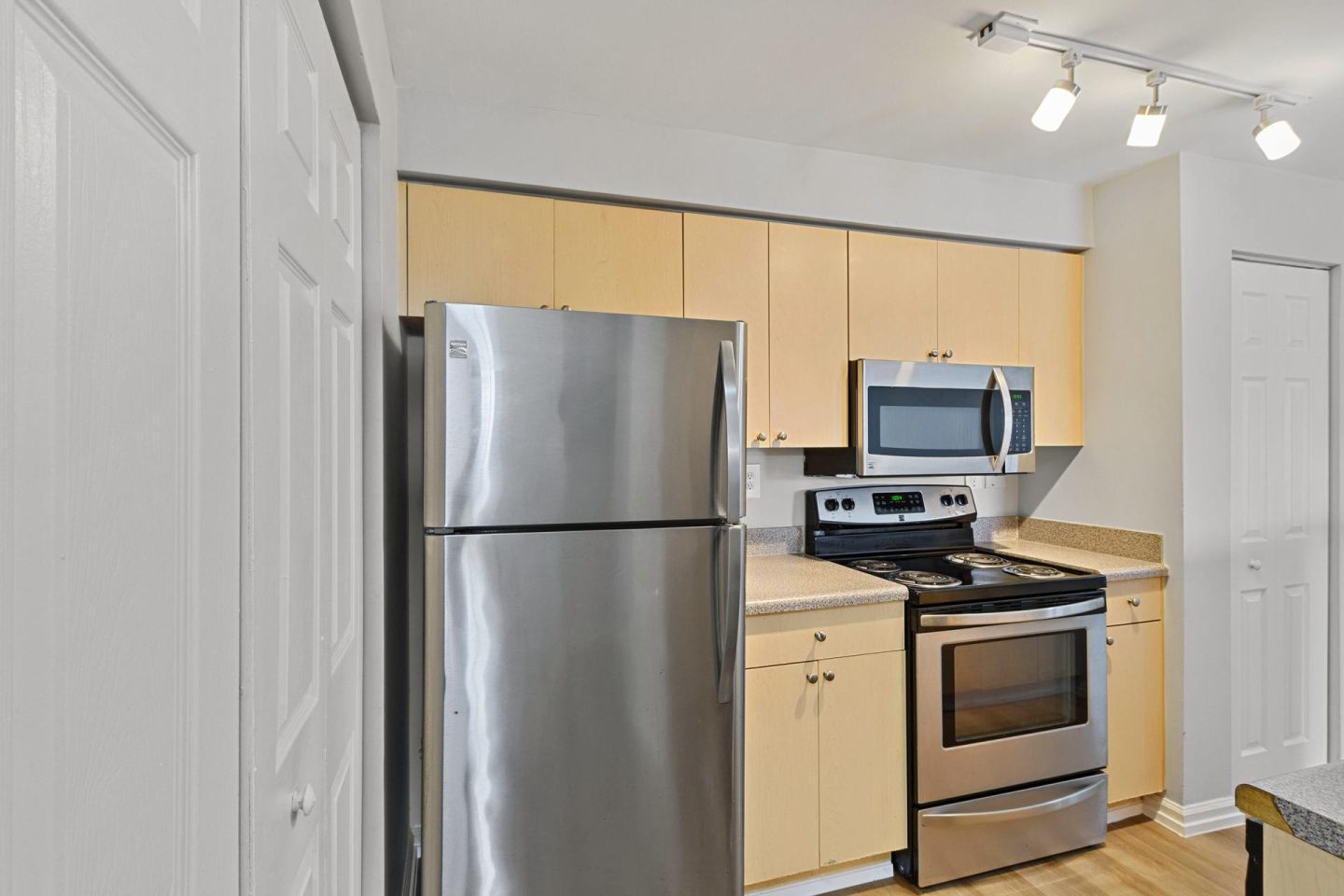 Partial classic finish kitchen with stainless refrigerator and range at Windsor Pembroke Pines, 11099 SW 5th Street, Pembroke Pines, FL 33025
